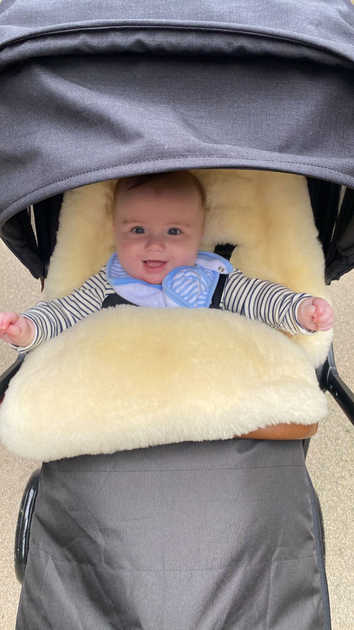 happy baby in pram smiling at camera